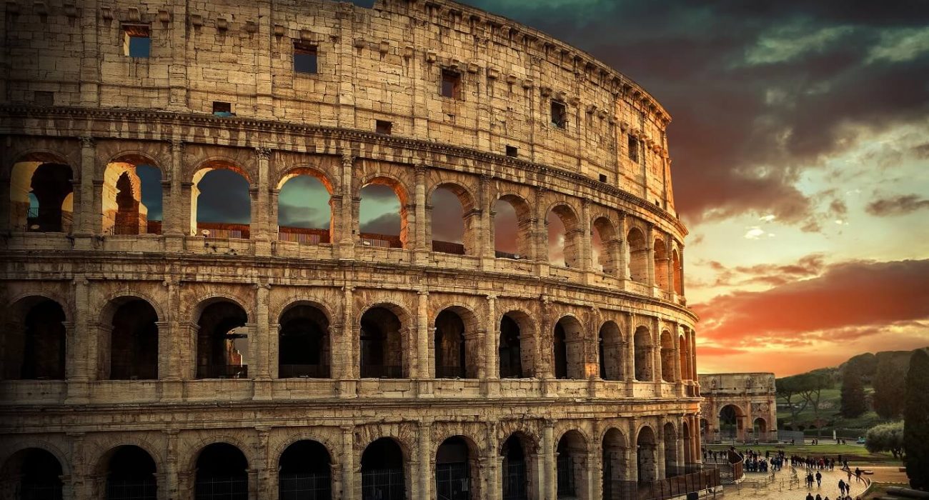 One of the most popular travel place in world – Roman Coliseum under evening sun light and sunrise sky.
